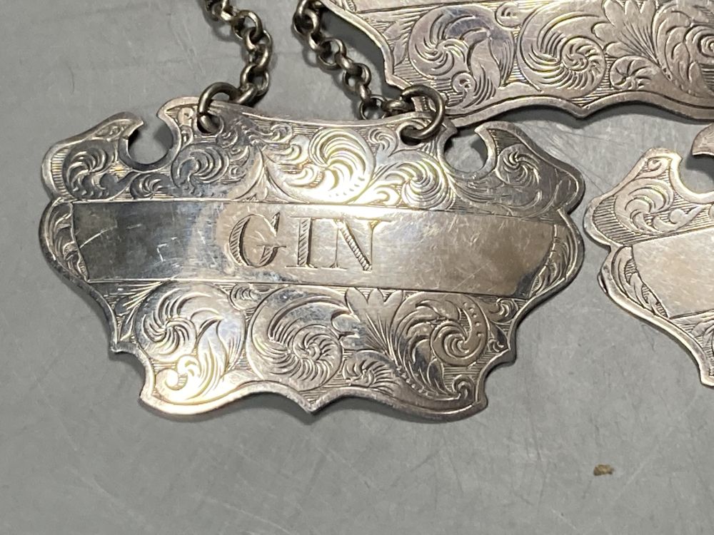 A matched set of three Victorian engraved provincial silver wine labels by William Rawlings Sobey,